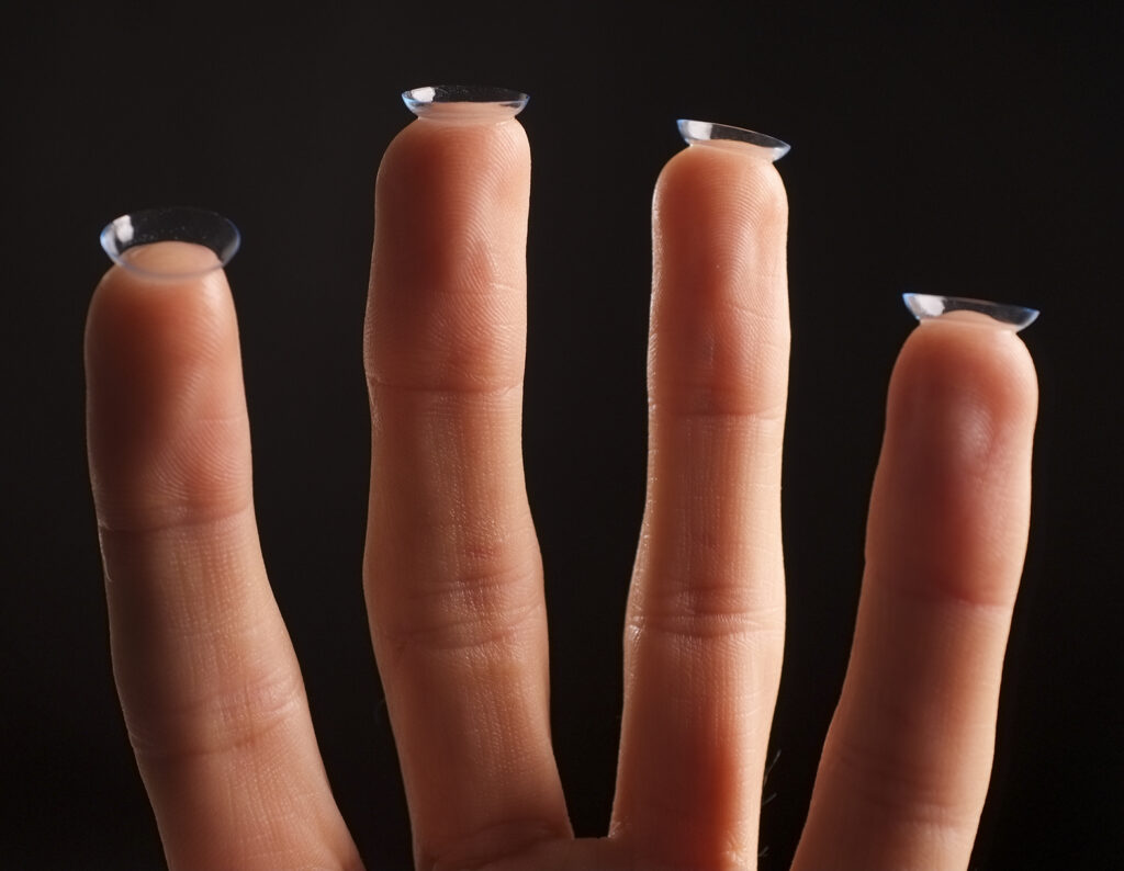Contact lenses on the end of fingers.
